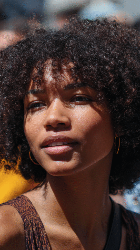 Playful curly shag haircut with a soft fringe, designed to enhance natural curls and add youthful charm.