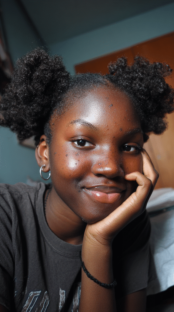 Mini afro puff hairstyle with playful, natural shape.