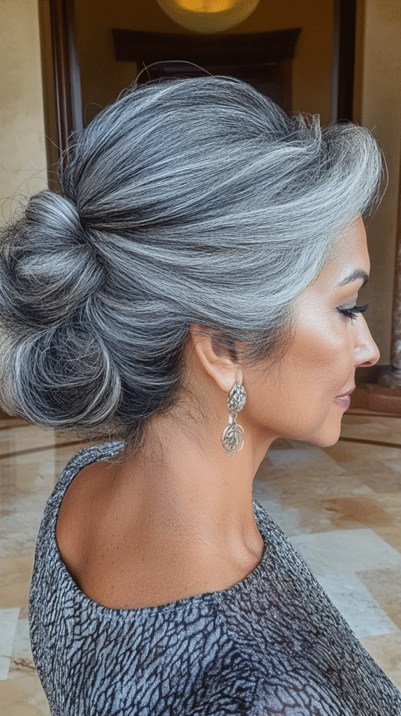 Twisted updo hairstyle interwoven with gray highlights.