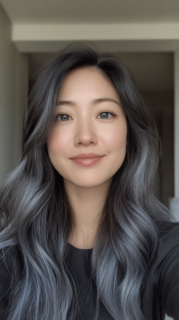 Subtle blue-grey lowlights placed underneath dark hair for hidden depth and dimension.