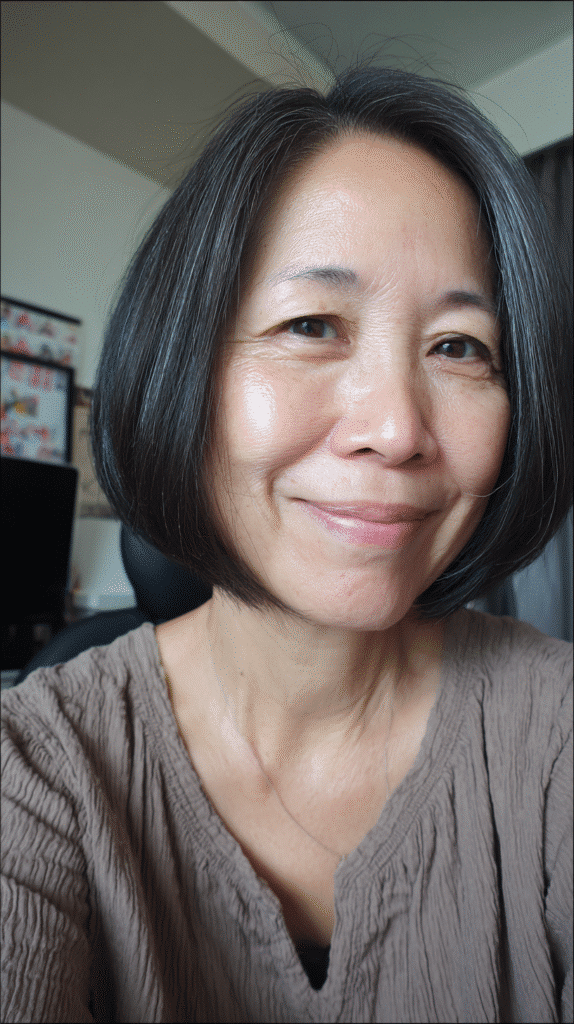 Woman with a sleek blunt bob, creating a fuller look with sharp, even ends.