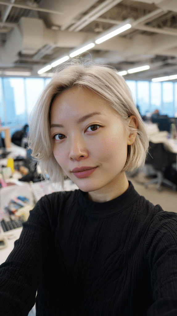 Woman with a sleek classic bob in steel-toned blonde.