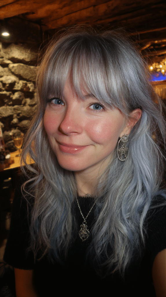 A textured dark shag cut with cool ice grey highlights concentrated on the ends.