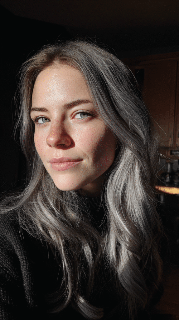 Face-framing layers colored in light grey to brighten and soften dark base hair.