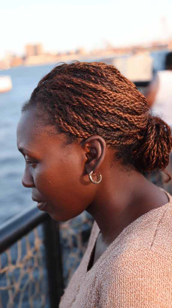 Woman wearing side braids leading into a low, romantic side bun.