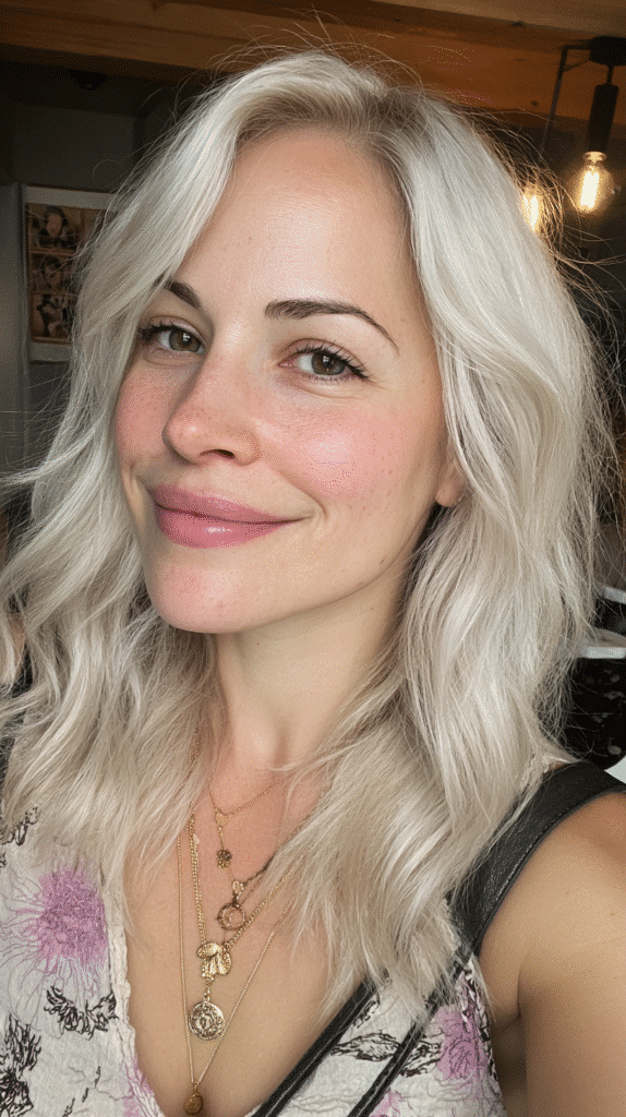 Woman with soft silvery champagne blonde waves.