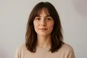A woman wearing a human hair lace front wig with soft curtain bangs that frame her face naturally